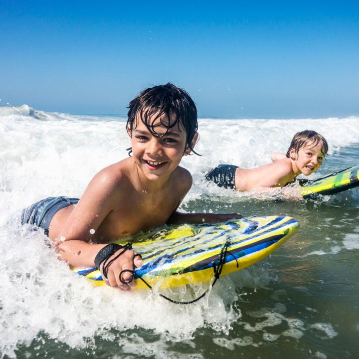 kids safely surfing on Woolacombe Beach North Devon